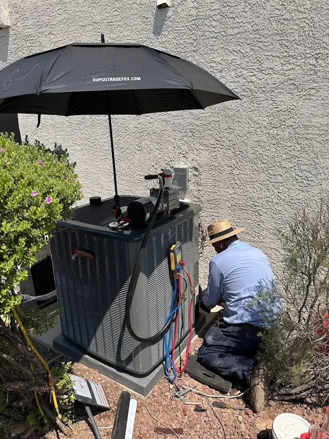 HVAC technician performing outdoor AC maintenance in Maple Heights